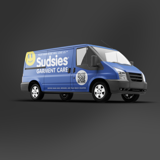 Blue Sudsies Garment Care delivery van with smiley face logo and QR code on the side.